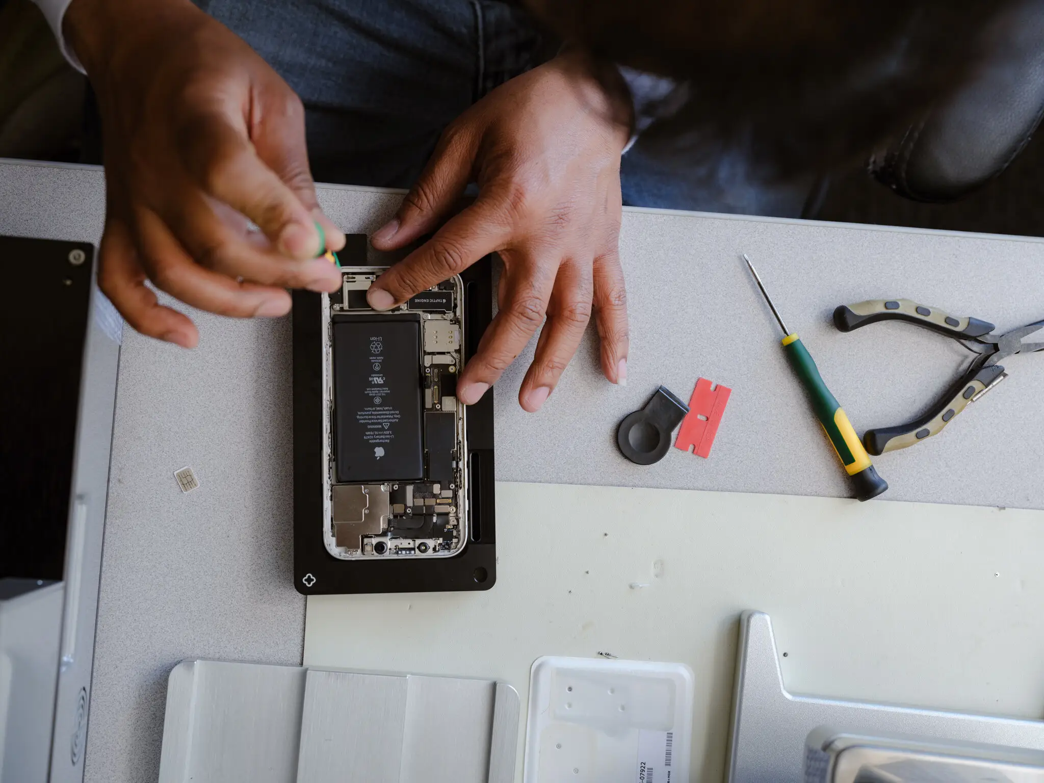 iPhone logic board and A-series chip shown during a repair assessment